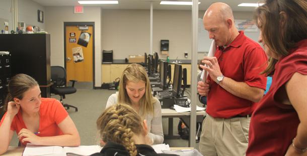 Engineering teacher Todd Peterson and Math teacher Susan Coffee give help to College Algebra students during the new Math and Science Seminar lab. 