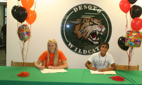 SENIORS SHELBY STEPHENS and Diego Sanchez publicize their college signing ceremonies at the De Soto High School library on May 13. Stephens signed to compete in track and cross country at Baker University. Sanchez signed to compete in track and cross country at Allen County Community College. Wildcat Photo