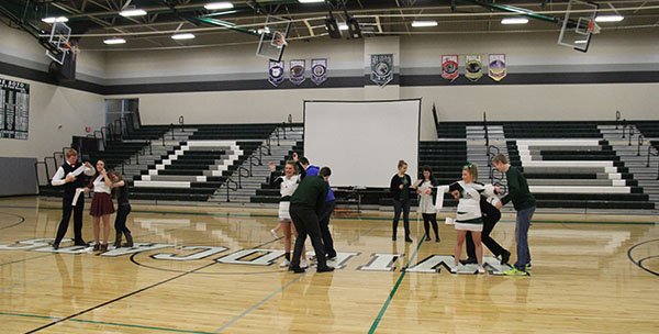 Queen of Winter Sport candidates participate in a game in which the men dressed the girls with toilet paper.