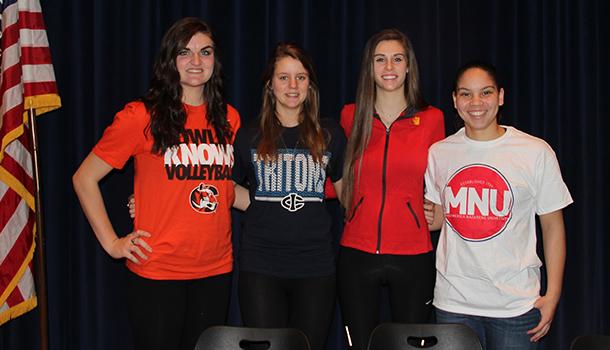 De Soto High School seniors Kenna Hall, Brittani Jenson, Meredith Wolfe and Tori Marshall take a group photograph after signing their letters of intent on Feb. 4, 2015. 