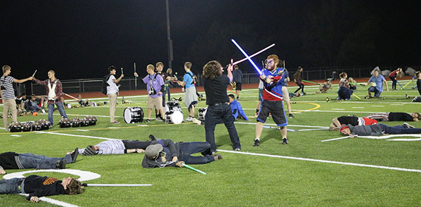 Members of the DHS marching band practice their light saber battle at a Monday night practice.