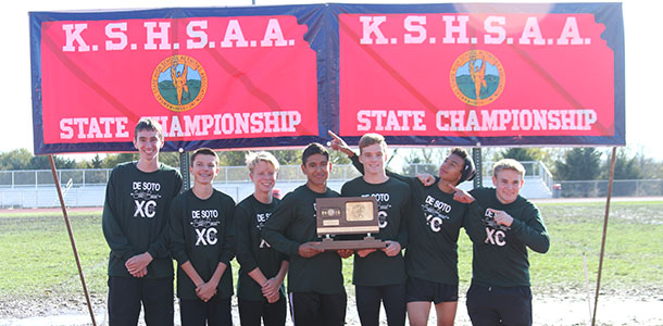 The boys' cross country team poses with their second place trophy at State.