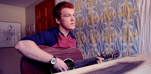 Simon Couch poses with his guitar on Jan. 25. 