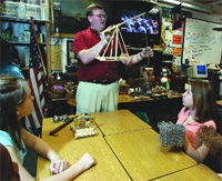 Hileman uses a prop to teach his middle school students.