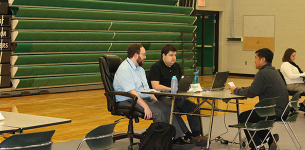 English teacher, Phil Hamilton, and student teacher, Jim Goss, meet with a parent on the Wednesday night of conferences.