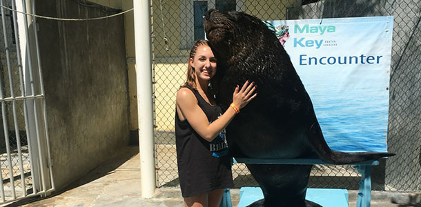 Fowks hugs a sea lion at an animal refuge in Maya Key.