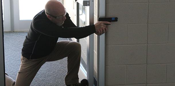 Art teacher Tim Mispagel plays the role of an active school shooter during ALICE Training at De Soto High School on March 11.