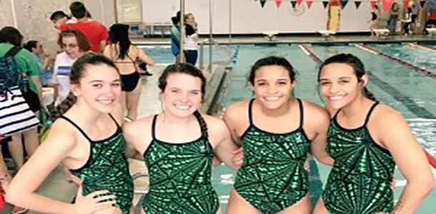 Gabby Mallozzi, Kayla Deghand, Kenzie Dalrymple and Haley Dalrymple pose before a swim meet on March 29.