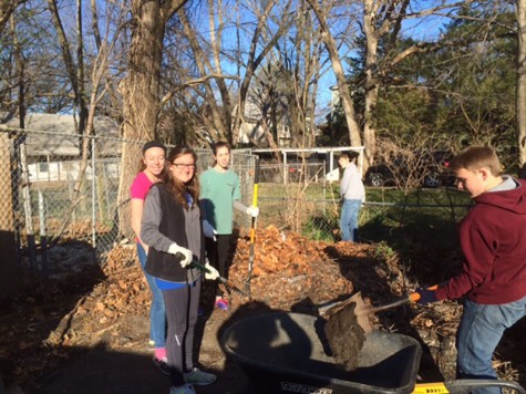 NHS members doing yard work at the Bonner Springs Animal Shelter.