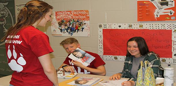 Senior Christa Stenzel being helped with blood drive sign ups by junior Taylor Ramseyer and freshman Alyssa Perry.