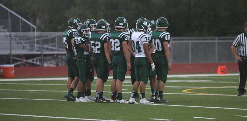 DHS football team prepares for kickoff in the rain at the Green White Scrimmage on Aug. 26.