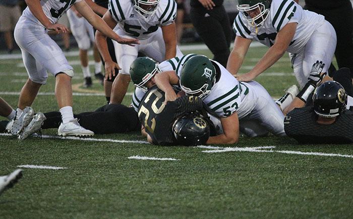 Junior Trevor Gress tackles the Paola fullback at the game on Sept. 23. The Wildcats eventually won 28-7.