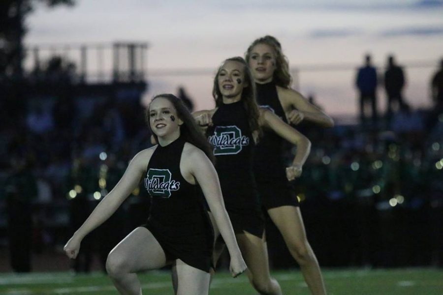 Junior Charisa Dodd and freshmen Jolie Dobosz and Ellie Warners perform at half time of the DHS football game on Friday Sept. 2