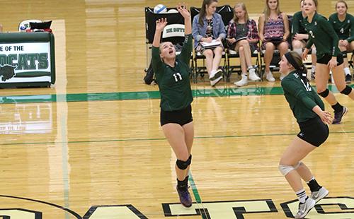 Sophomore Haley Cuba sets the ball to Senior Jackie Kennard at a game versus Louisburg High School.