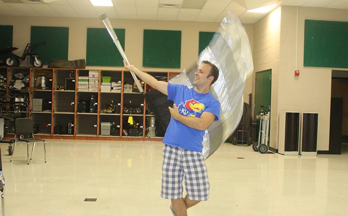 Elliott demonstrates some of his flag work after a Monday night rehearsal.