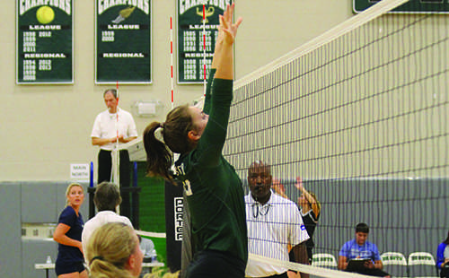 Senior middle hitter Jackie Kennard goes up to block a hit at the Spikefest tournament on Oct. 8.