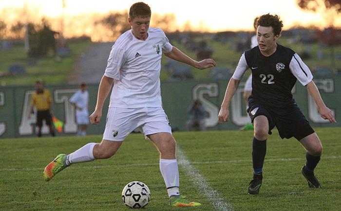 Junior Andrew Goodman dribbles the ball towards the goal against St. James Academy. The game resulted in a 7-0 loss for DHS, eliminating them from the State competition. The team ended with a winning season of 12-6-0.