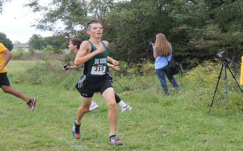 Sophomore Sam Hubert races to the finish line during the cross country meet at Shawnee Mission Park.