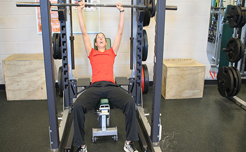 Physical education teacher Junelle Woolery lifts during her plan period on Dec. 8.