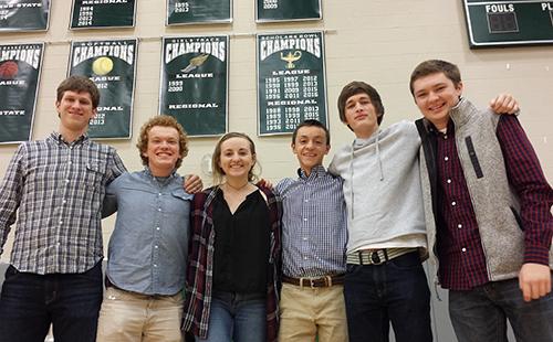 Seniors Dawson Field, Simon Couch, Mackenzie Smith, Ian Clouston, Trevor Whitlow and junior Cody Moose pose in front of the Scholars Bowl banner, with a freshly added '2016' under League champions. 