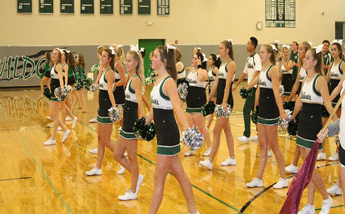 Kira Horn cheers with the De Soto High School cheer team on Freshman Day.