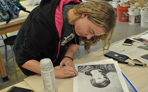 Senior Emily Euler works on an art piece she submitted for Shooting Stars 