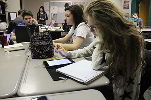 Juniors Grace Lindsey, Keirstyn Mascareno and Johnny Meehan work on cutting their pieces.