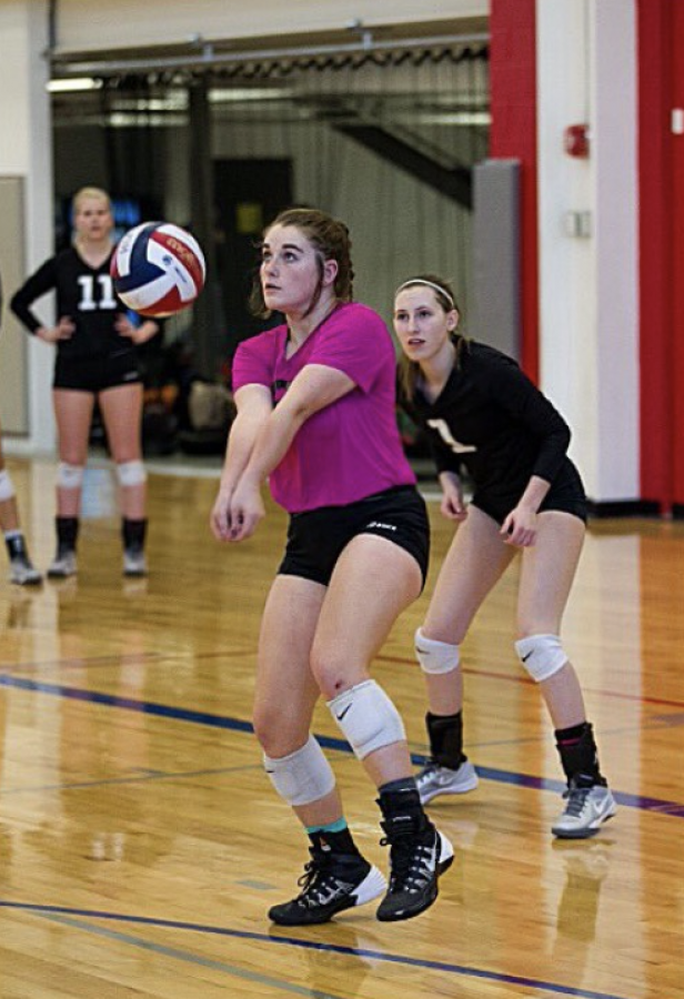 Junior Alexa Rosetta passes a volleyball during a game.