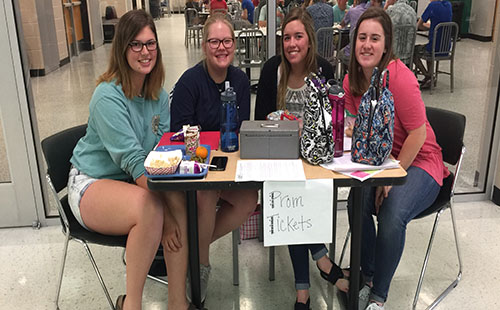 Juniors Josie Bedford, Hannah Knight, Payton Faddis and Rachael Hopkins sell prom tickets at lunch on April 19.