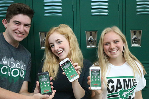 Several Green Pride staff members showing off the new Wildcat Nations app on August 25.