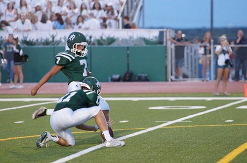 Senior Ethan Rodriguez, who plays for both the DHS soccer and football teams, kicks a PAT during the 2016 season. 