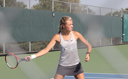 Varsity tennis player and senior Carly Bodenhausen prepares to hit a forehand at the De Soto Quad on Sept 11.