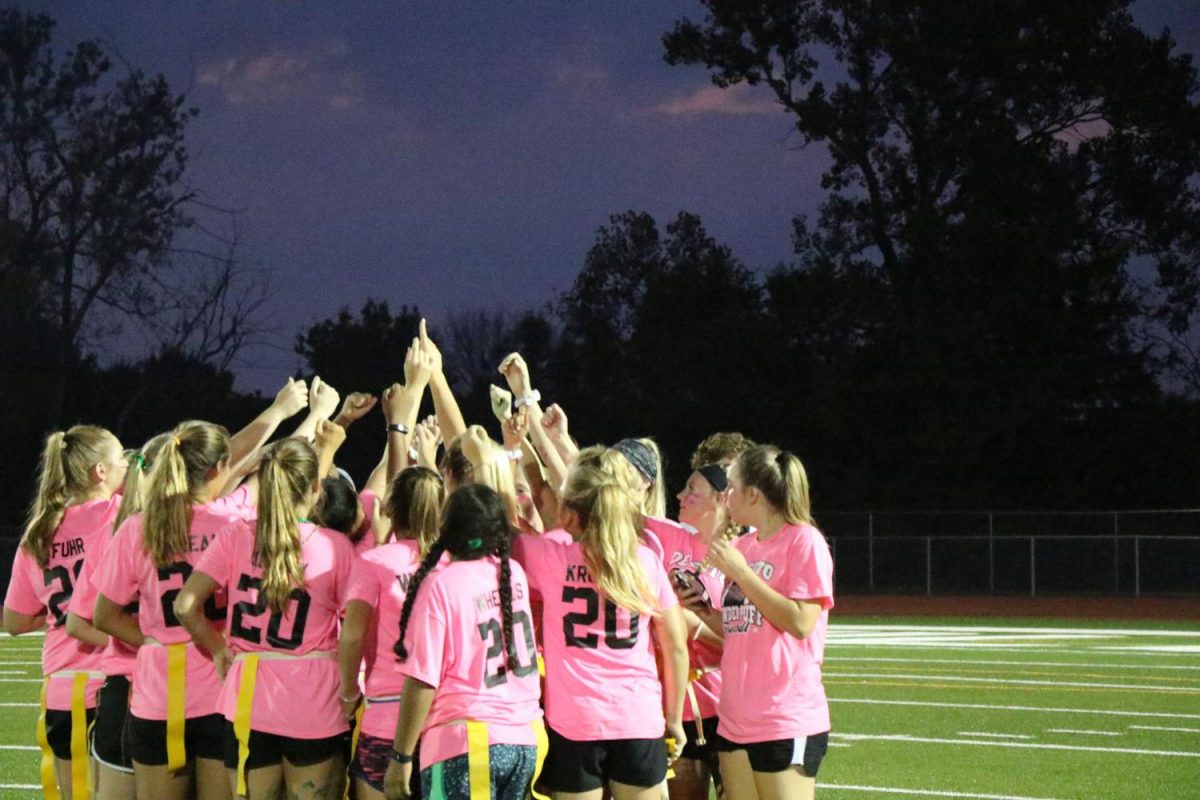 The sophomore team huddles before the first play at the powder puff football game on Sept. 20. Photo by Rylee Wilson.