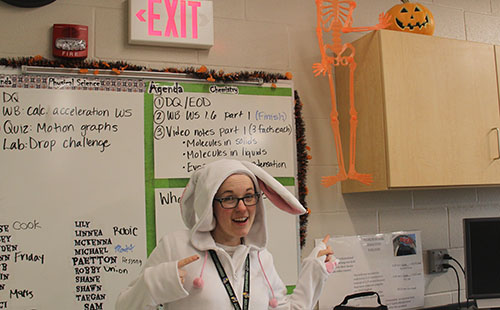 Laura Sixta stands with Halloween decorations in her class room on 10/31