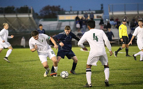 Senior Andrew Goodman fights for the ball while junior Rohan Singh prepares to defend on Oct 24.