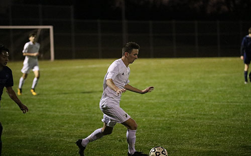 Junior Carson Brier dribbles the ball down the field on Oct 24.