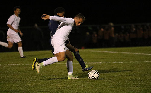 Senior Ethan Rodriguez tries to shake off the player from Olathe West High School at the game on Oct. 24