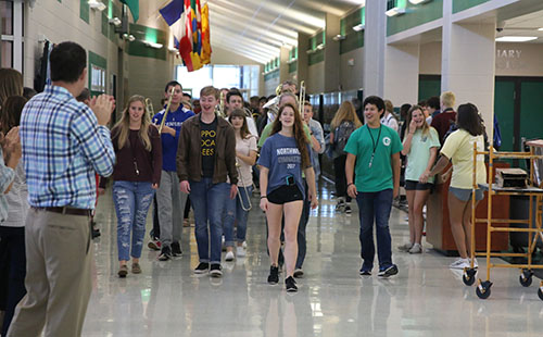 Freshman Molly Stack walks at the front of the gymnastics State sendoff on Oct. 19.