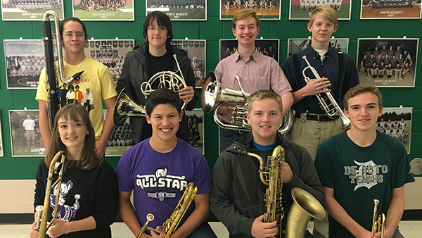 Members of the NEKMEA District Honor Band pose with their instruments. 