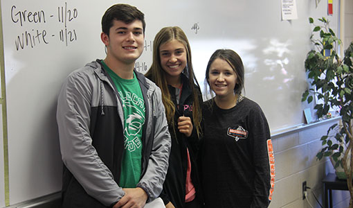 Senior John Kraus and juniors Maya Bascom and Lauryn Williams mentor freshmen in Katie Wilber's Seminar class on Nov. 16.