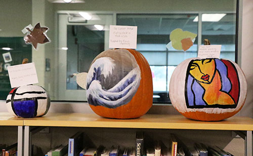 Student's pumpkins being displayed in the media center window.