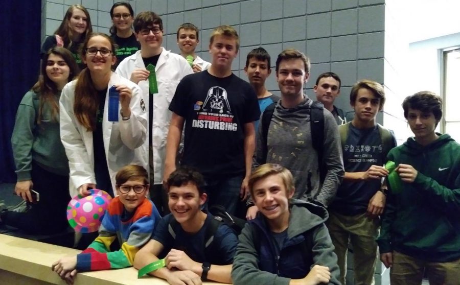 The De Soto Science Olympiad team gathers by the Olathe North stage at the "O-Town Throwdown" meet on Nov. 18. Seniors Kay Craven, Zach Deibert and Micah Faulds and freshmen Brent Smith and Avery Hantla displayed the ribbons after placing in their events.