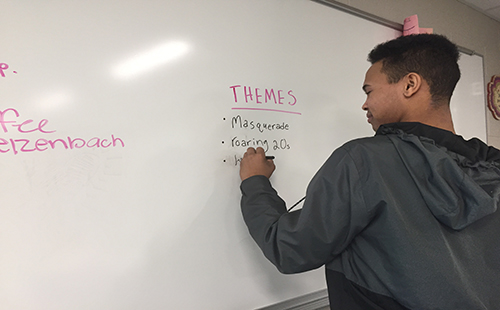 Junior Zekkiah Hird writes down the prom theme ideas that the committee brainstorms.