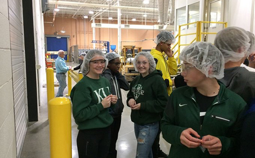 Sophomores Addison Gress and Katelyn Marti pose for a picture during a tour of the Huhtamaki facility while on a field trip for Business Essentials on Dec. 5.  
