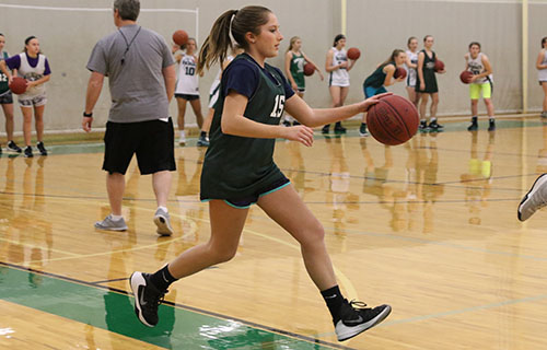 Sophomore C team player Emilee Mills dribbles the ball at practice on Dec. 7.