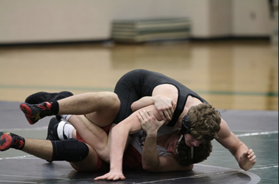 Sophomore Luke Barger wrestles an opponent from Highland Park at De Soto High School on Jan. 24.
