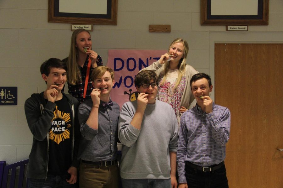 Seniors Abigail Stutzman, Elizabeth Seidl, Ben Sickert, Zach Yarbrough, Micah Faulds and Cody Moose celebrate after their win at League at Baldwin High School on Jan. 8.