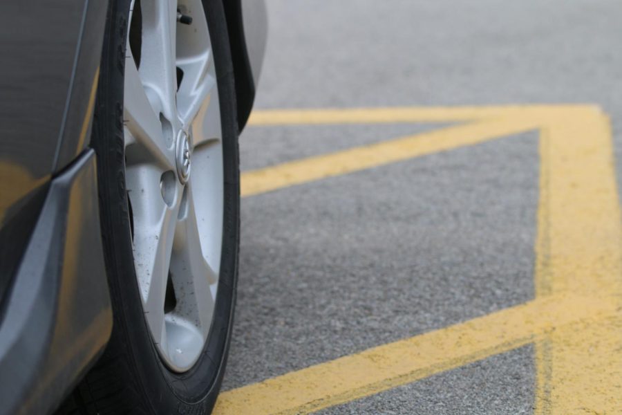 A car is parked illegally in a lined non-parking area during the school day at De Soto High School because there were no open spots on March 29.