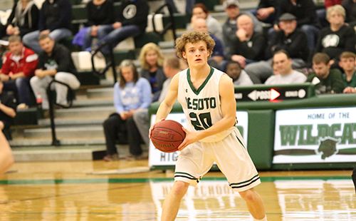 Senior Brannon Bell looks for a open spot to pass the ball during a game against Paola on Feb. 9. 