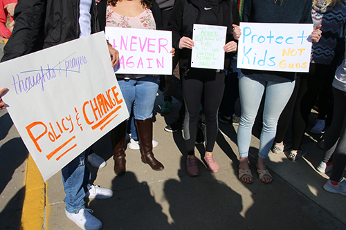 Students display signs they created for the walkout on March 8. Photo by Reaghan Wharff.